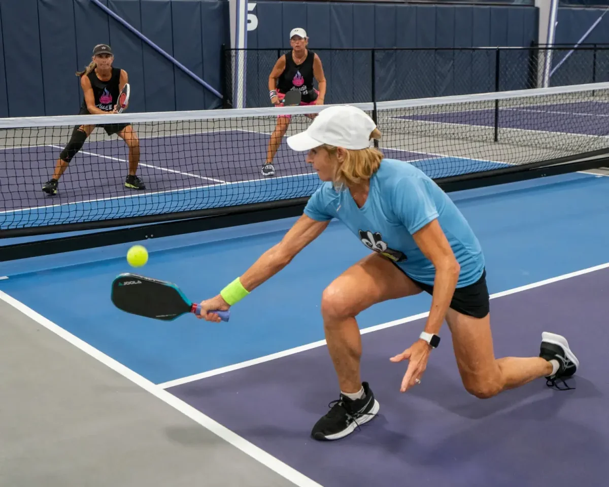 Low kitchen shadow lunge and hold drill training quadricep endurance at the non-volley zone line