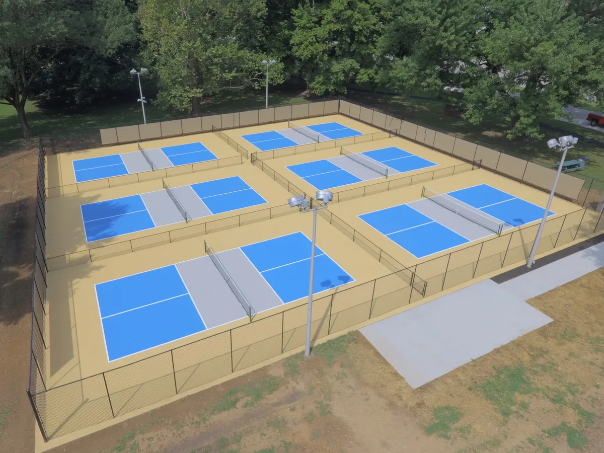 Newly resurfaced tournament pickleball court featuring two-tone blue and green 100% acrylic coating