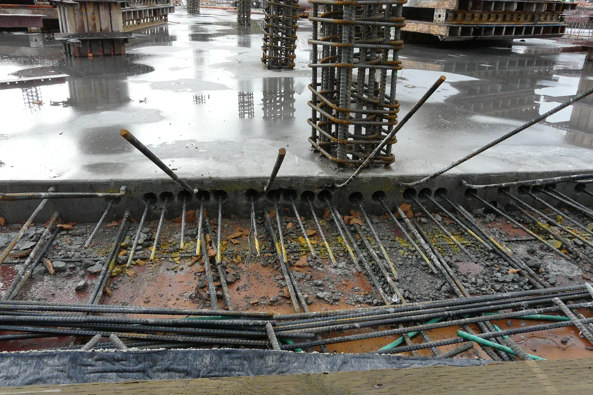 Post-tensioned concrete slab foundation construction showing high-strength steel tendon cables