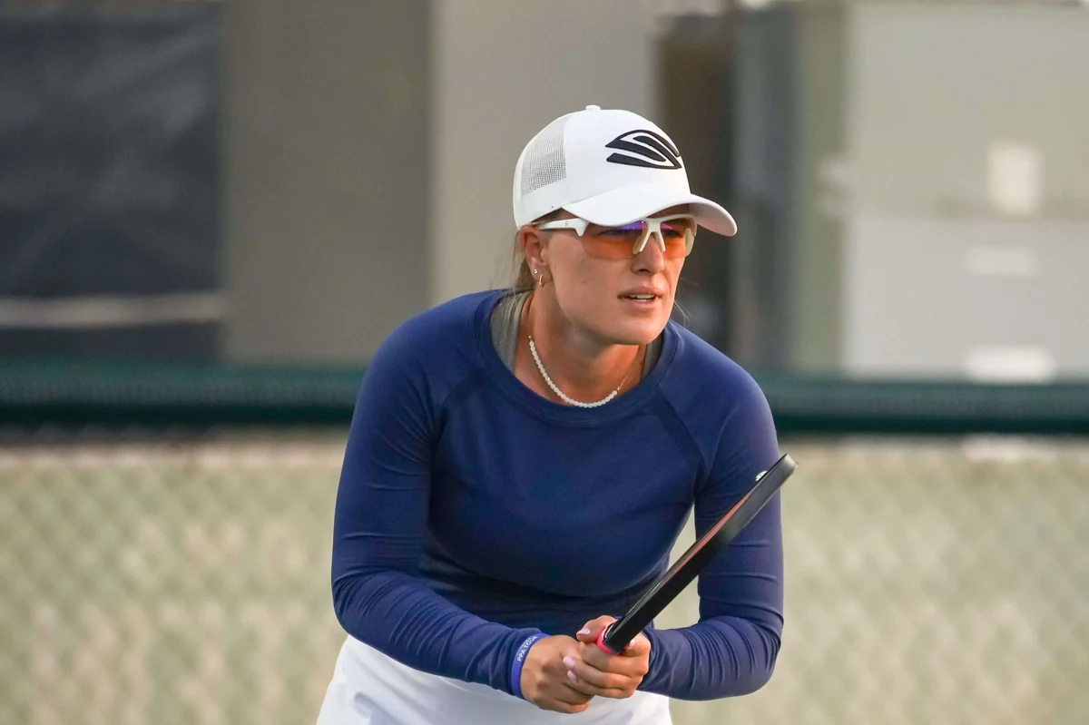 Professional pickleball player Mary Brascia on court wearing RIA eyewear with high-contrast amber yellow low-light lens